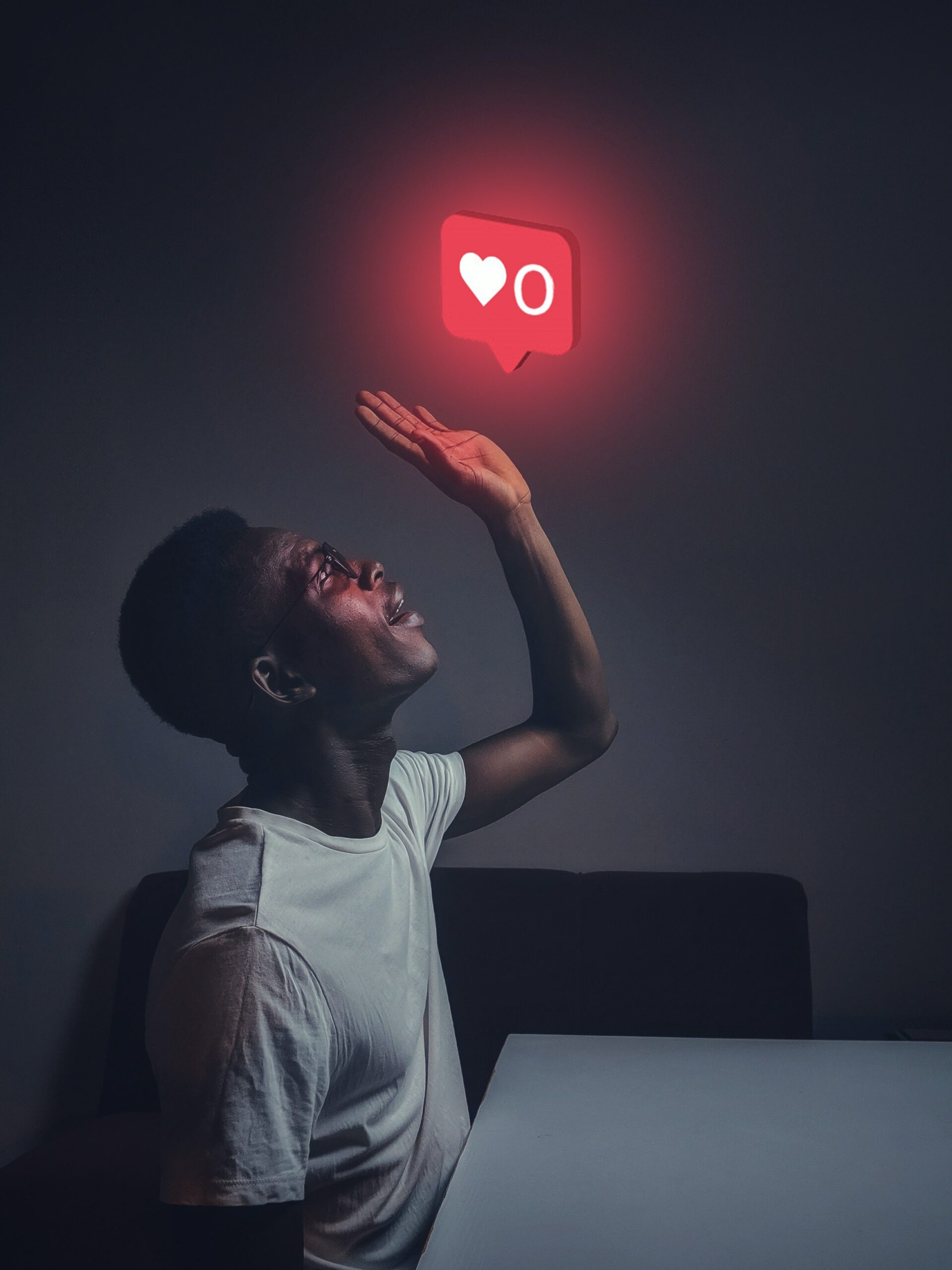 Man reaching for the like symbol on Instagram, social media benchmarking